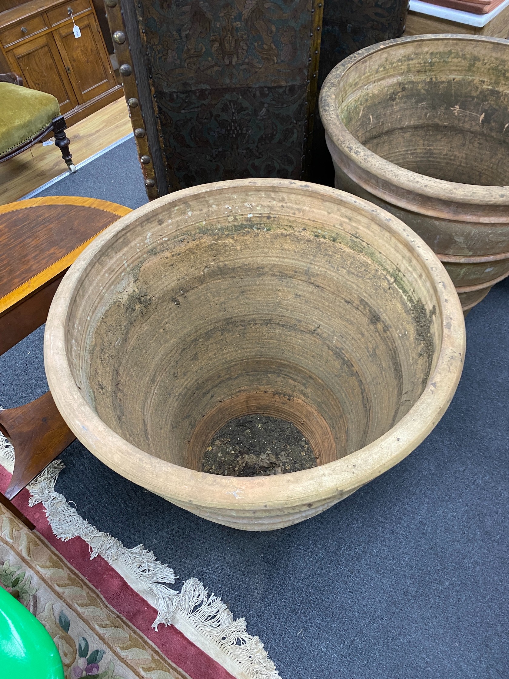 A near pair of Grecian style circular earthenware garden planters, larger diameter 82cm, height 82cm